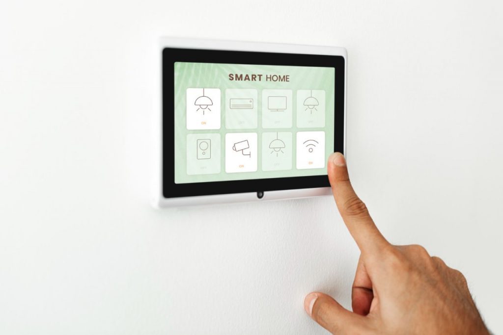 finger pressing smart home automation panel monitor